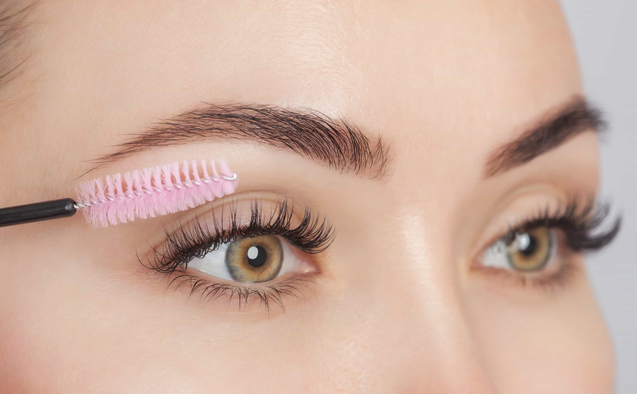 Beautiful Woman With Long Eyelashes In A Beauty Salon. Eyelash Extension Procedure. Cosmetology Skin Care